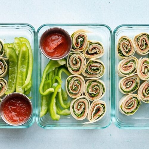 Three pizza roll up lunch boxes lined up in a row
