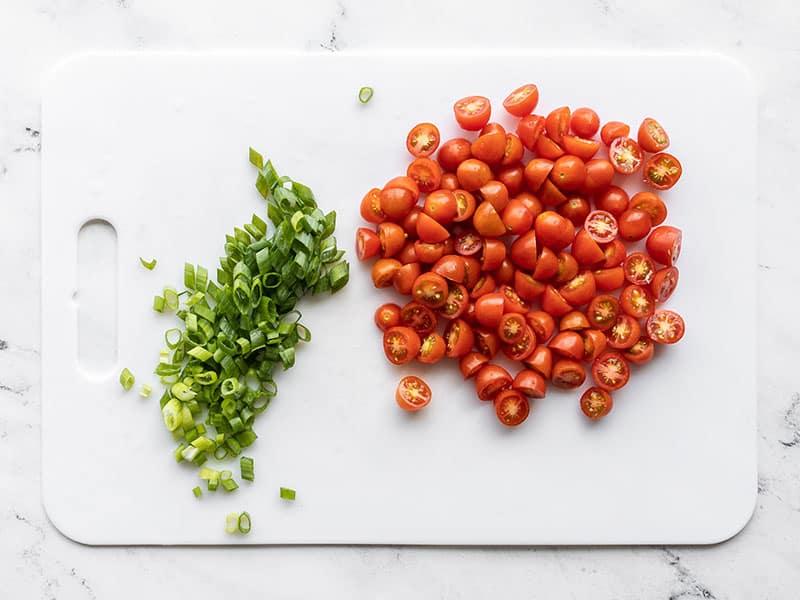 Sliced green onion and grape tomatoes