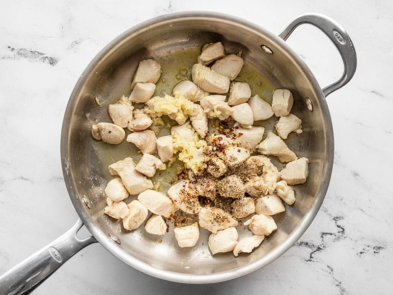 Cooked chicken in the skillet with spices.