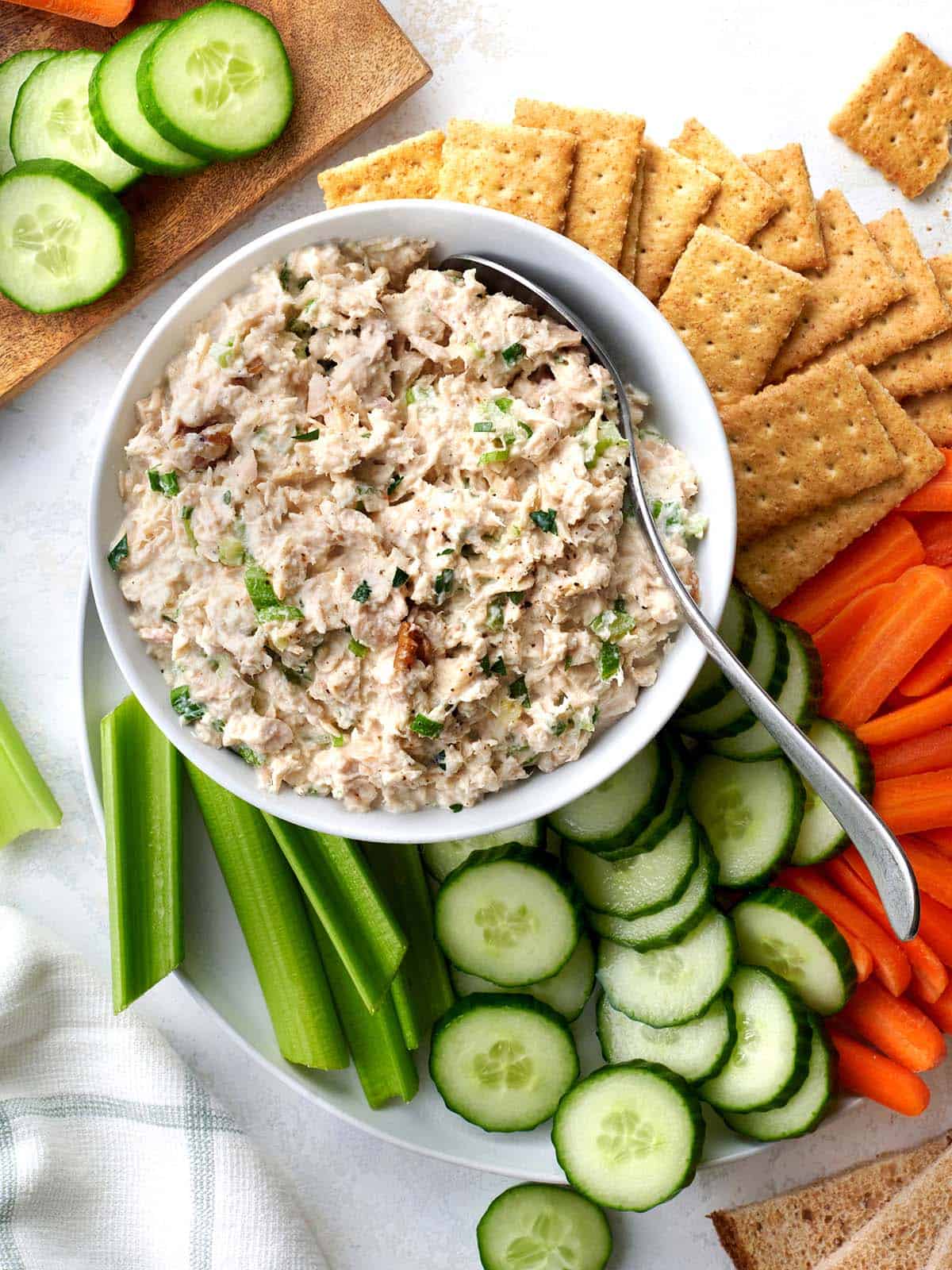 Say goodbye to gloopy, bland tuna salad and hello to a delicious tuna salad packed with flavor and texture! Perfect for brown bag lunches. Budgetbytes.com Overhead view of a bowl of homemade tuna salad surrounded by crudites and crackers.