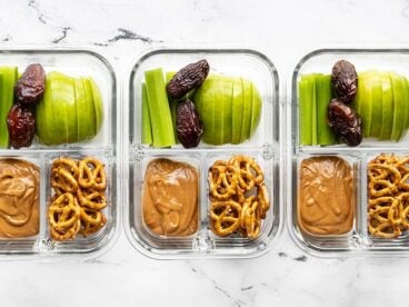 Three glass containers of the peanut butter lunch box lined up in a row