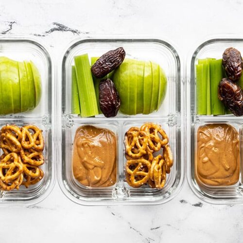 Three glass containers of the peanut butter lunch box lined up in a row