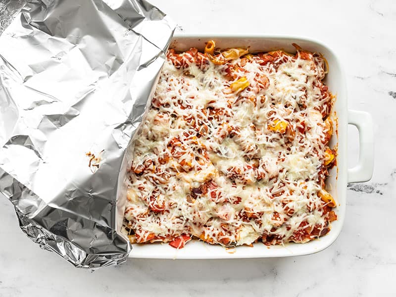 Baked Penne casserole with foil covering half the dish