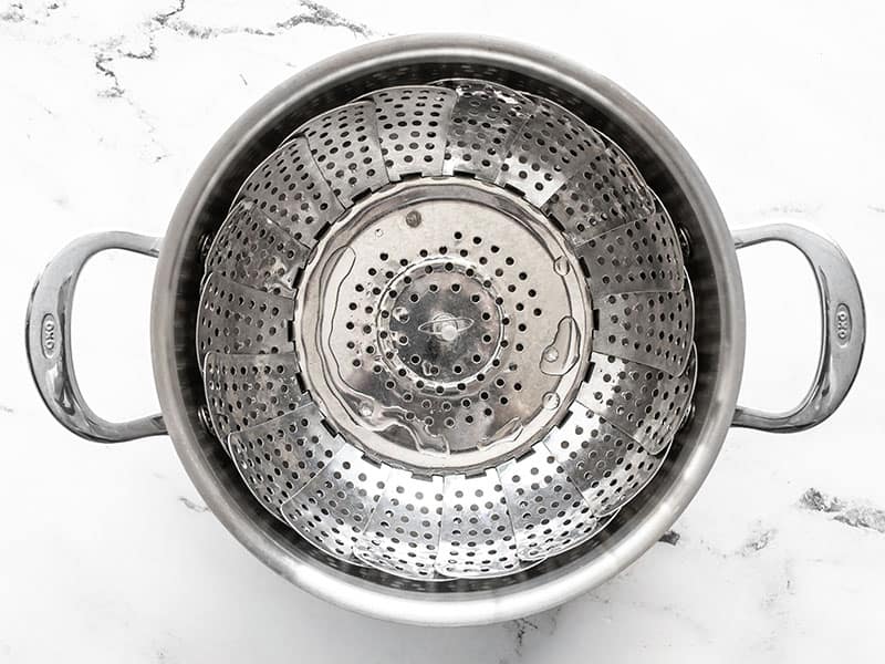 Steam basket in a pot with water