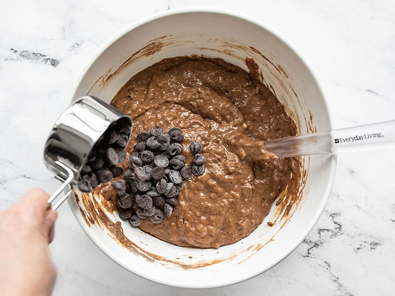 Chocolate chips being added to the batter