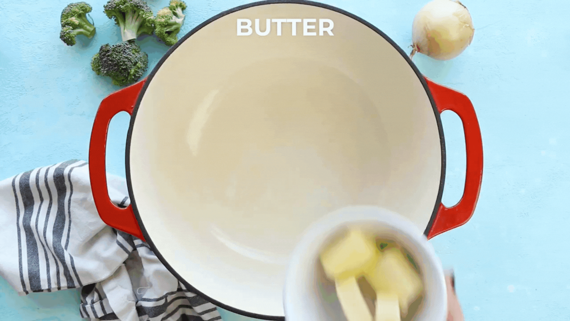 A video GIF showing butter and diced onion being added to a pot with flour.
