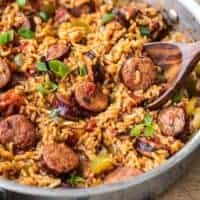 Side view of a skillet full of Cajun Sausage and Rice