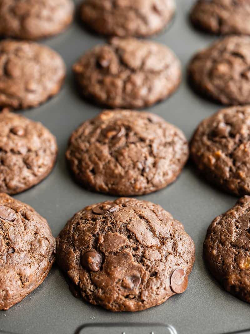 Chocolate Banana Muffins are a delicious freezer-friendly sweet treat, and a great way to use up brown bananas so they don't go to waste! Budgetbytes.com Close up front view of the chocolate banana muffins in the tin
