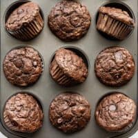 Chocolate Banana Muffins in a muffin tin, some turned on their side