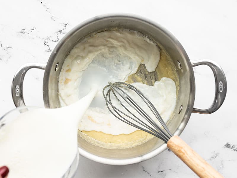 milk being poured into the pot