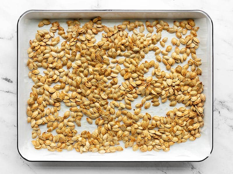 Roasted pumpkin seeds on a baking sheet