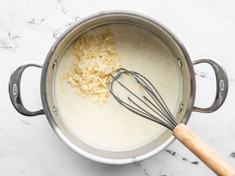 shredded cheddar added to the pot