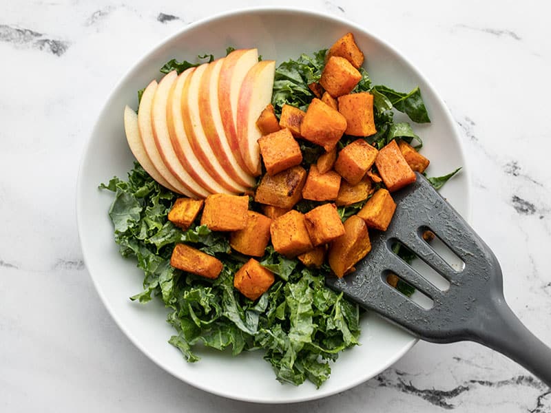 kale, apple, and sweet potato in a bowl