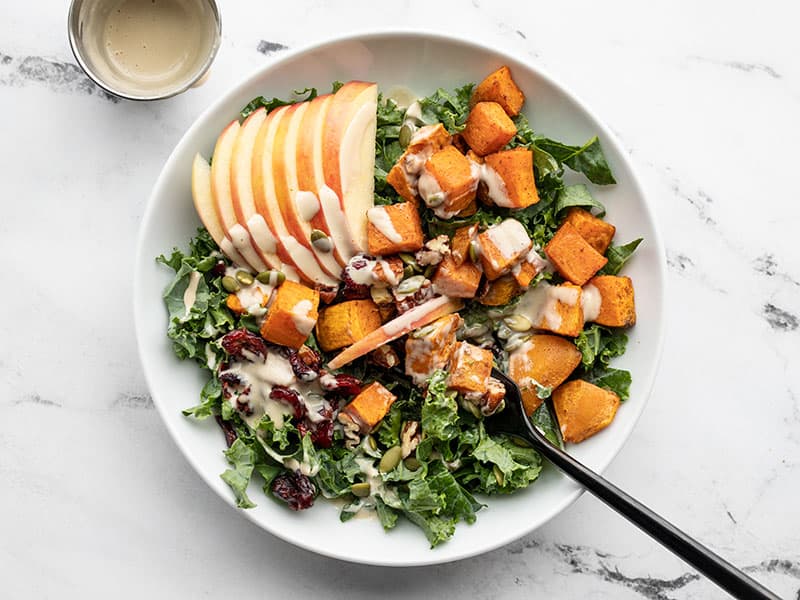 autumn kale and sweet potato salad being eaten