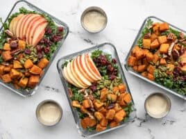 meal prep containers full of autumn kale and sweet potato salad