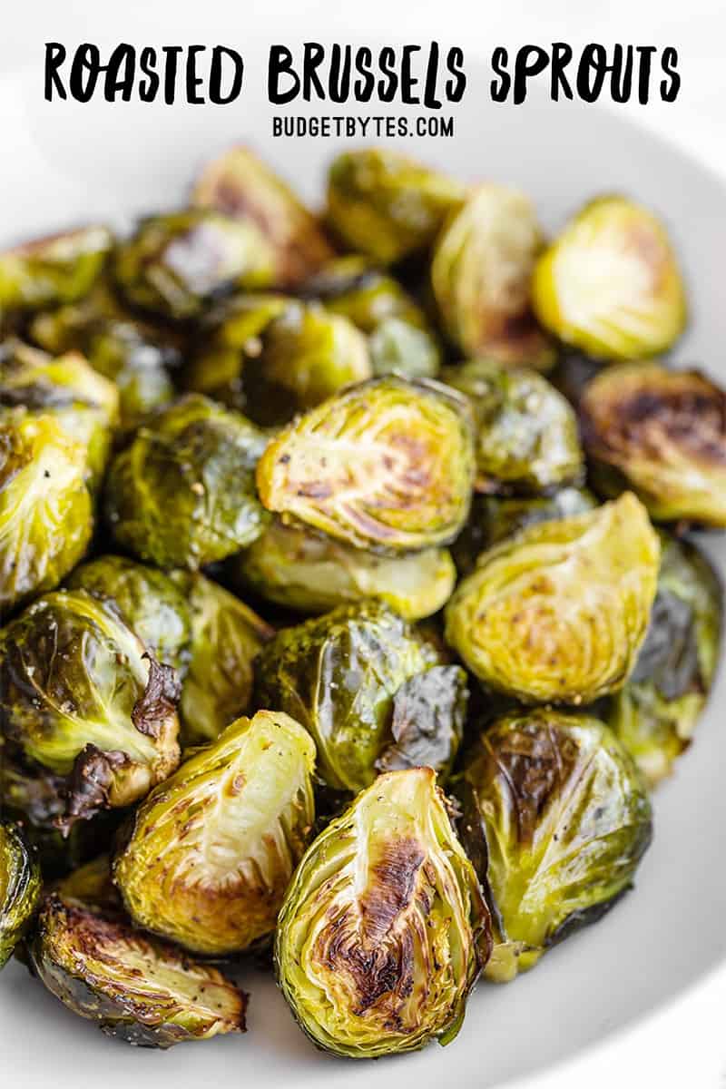 Close up side view of roasted Brussels sprouts with title text at the top