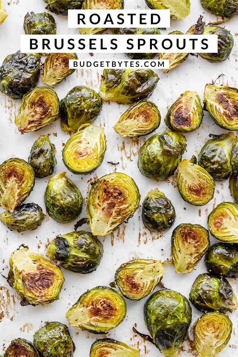 Overhead of roasted Brussels sprouts on a baking sheet, title text at the top