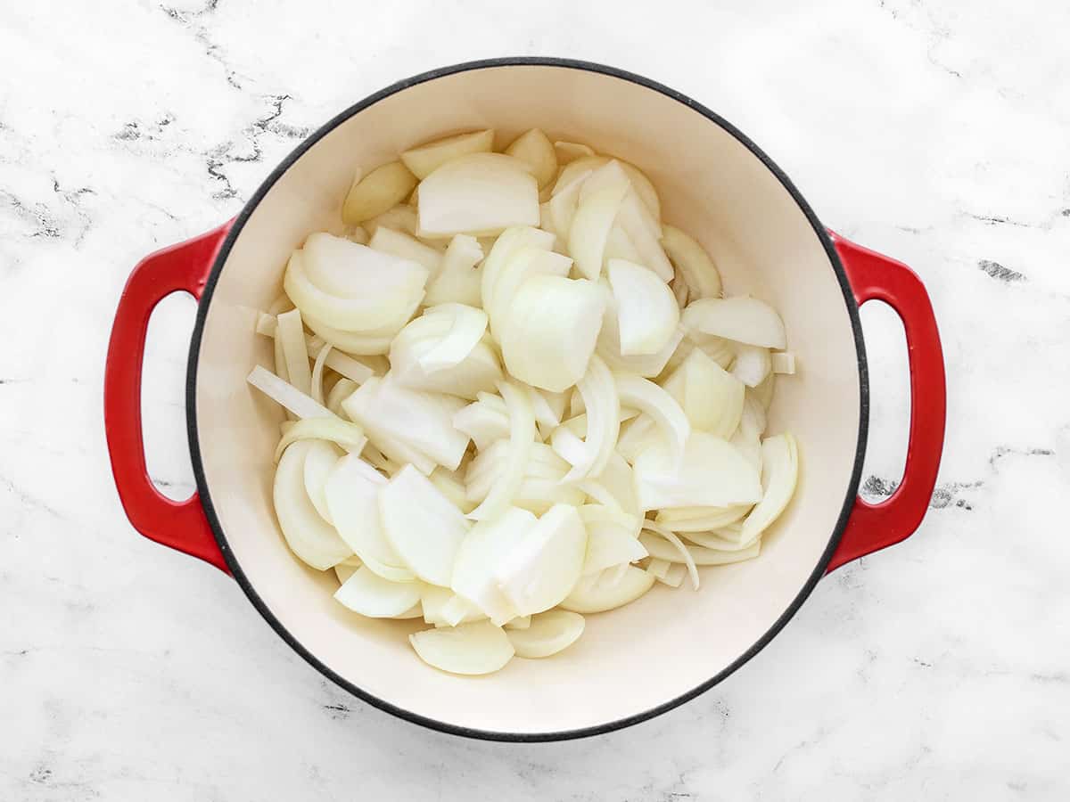 Sliced onions in a soup pot