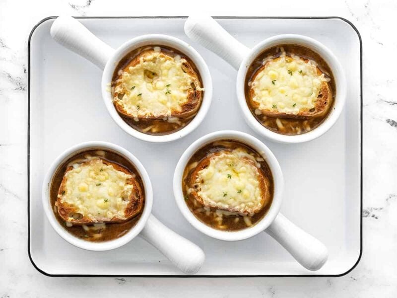 Boiled bowls of french onion soup with bread and cheese
