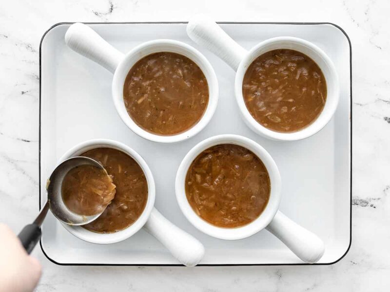 Soup being portioned into oven safe bowls