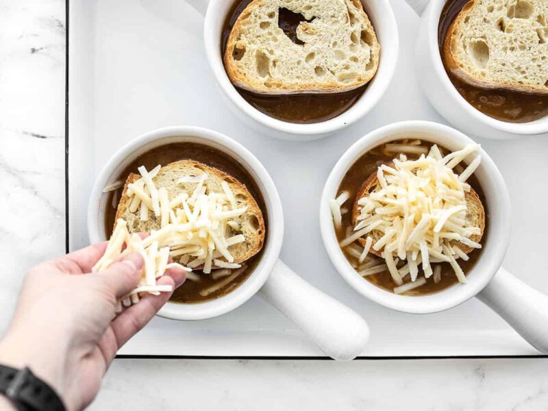Toasted bread and cheese added to the soup bowls