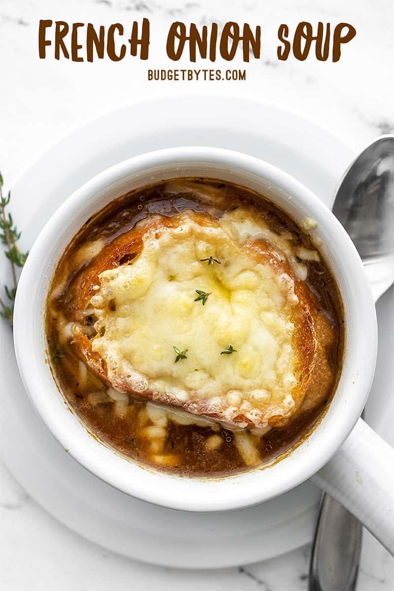 Overhead view of one bowl of french onion soup with title text at the top