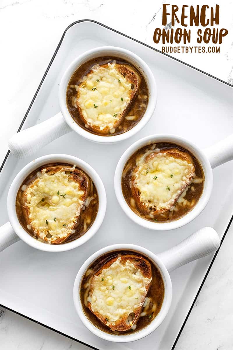 Four bowls of french onion soup on a tray, title text at the top