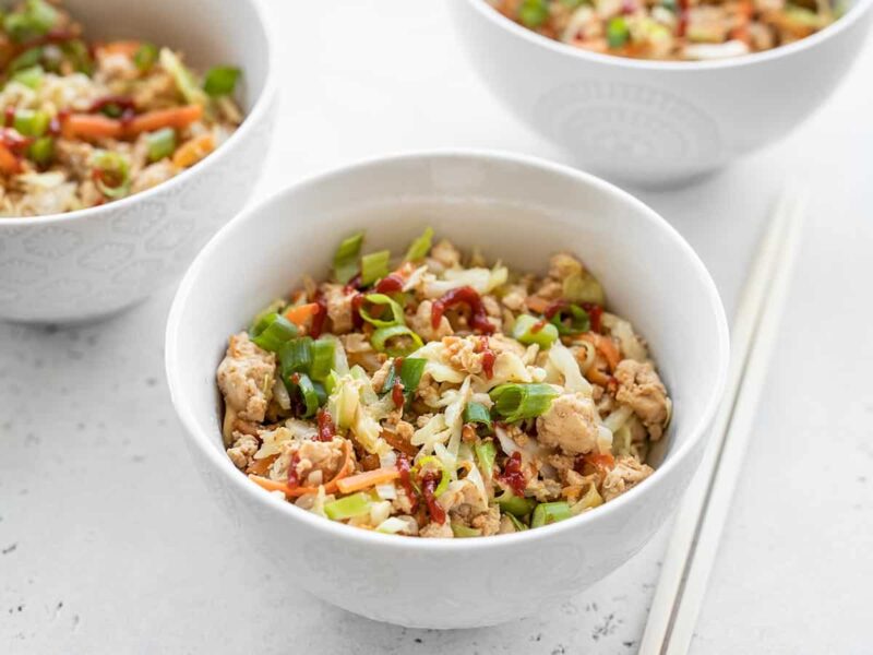 This super fast and inexpensive tofu stir fry is super filling, easy enough for busy weeknights, and endlessly customizable! Budgetbytes.com front view of three bowls full of quick tofu stir fry