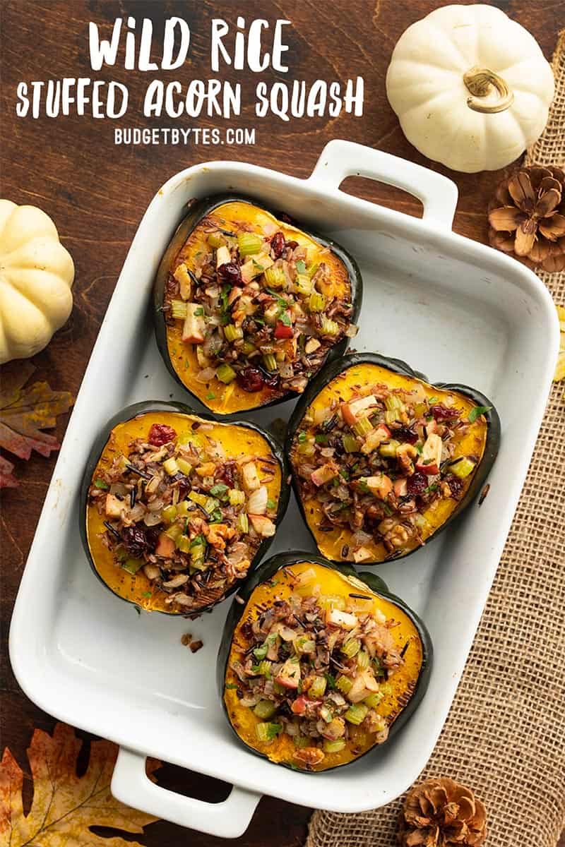 wild rice stuffed acorn squash in a casserole dish with title text at the top