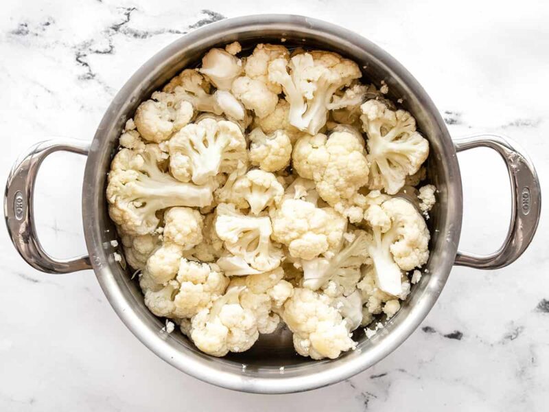 Cauliflower florets in a pot of water