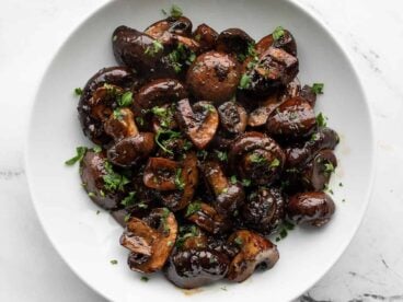Overhead view of balsamic roasted mushrooms in a white bowl