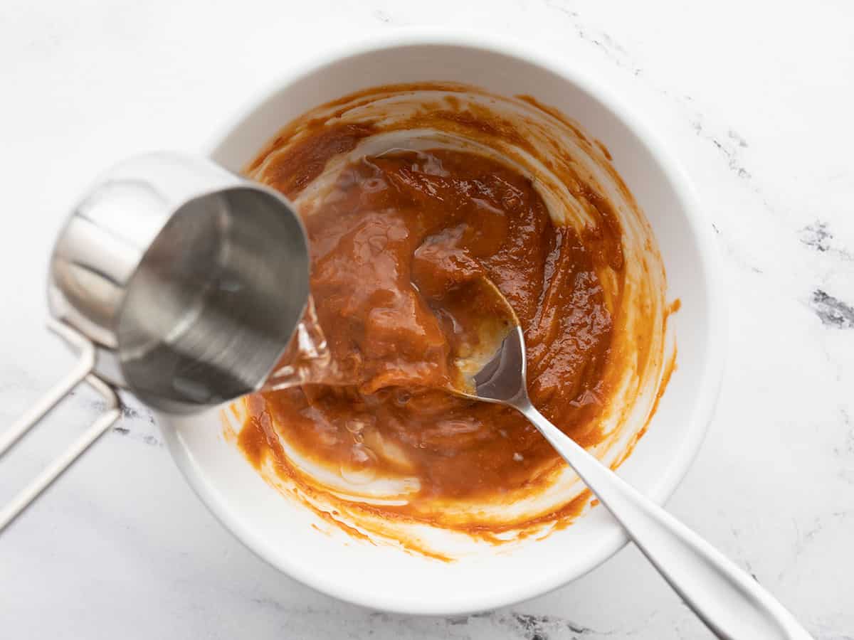 Hot water being poured into the peanut paste