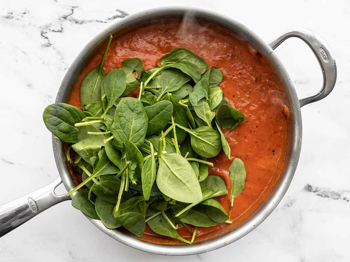 fresh spinach added to the sauce