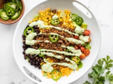 overhead view of turkey taco salad drizzled with creamy avocado dressing