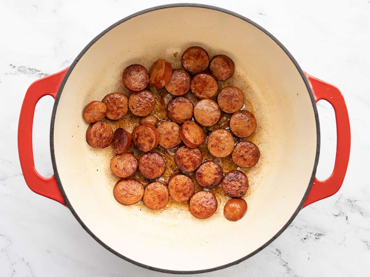 browned sausage rounds in a pot