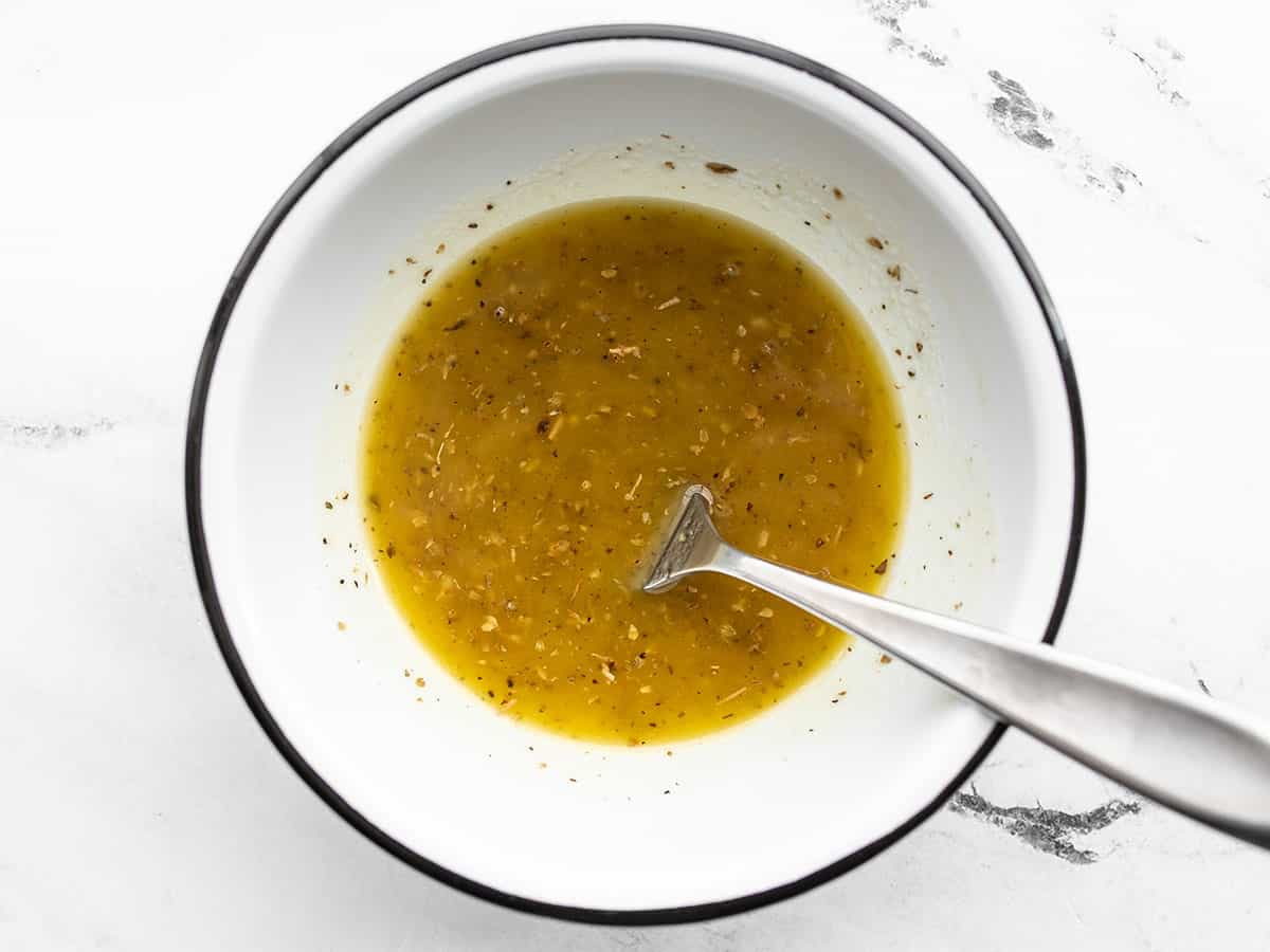Homemade vinaigrette in a bowl with a fork
