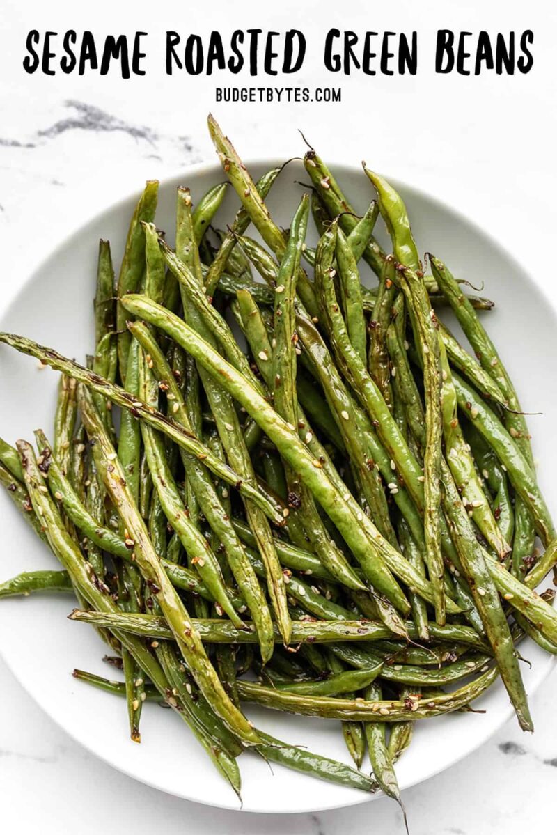 Overhead view of sesame roasted green beans, title text at the top