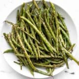 Sesame roasted green beans on a plate, viewed from above