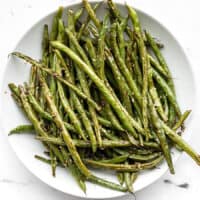 Sesame roasted green beans on a plate, viewed from above