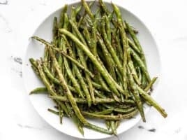 Sesame roasted green beans on a plate, viewed from above