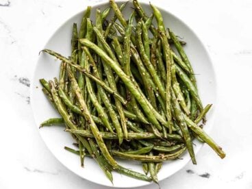 Sesame roasted green beans on a plate, viewed from above