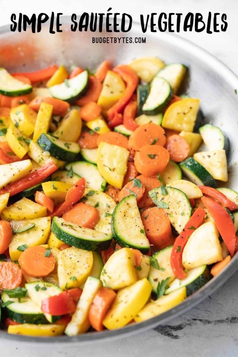 Close up side view of sautéed vegetables in a skillet