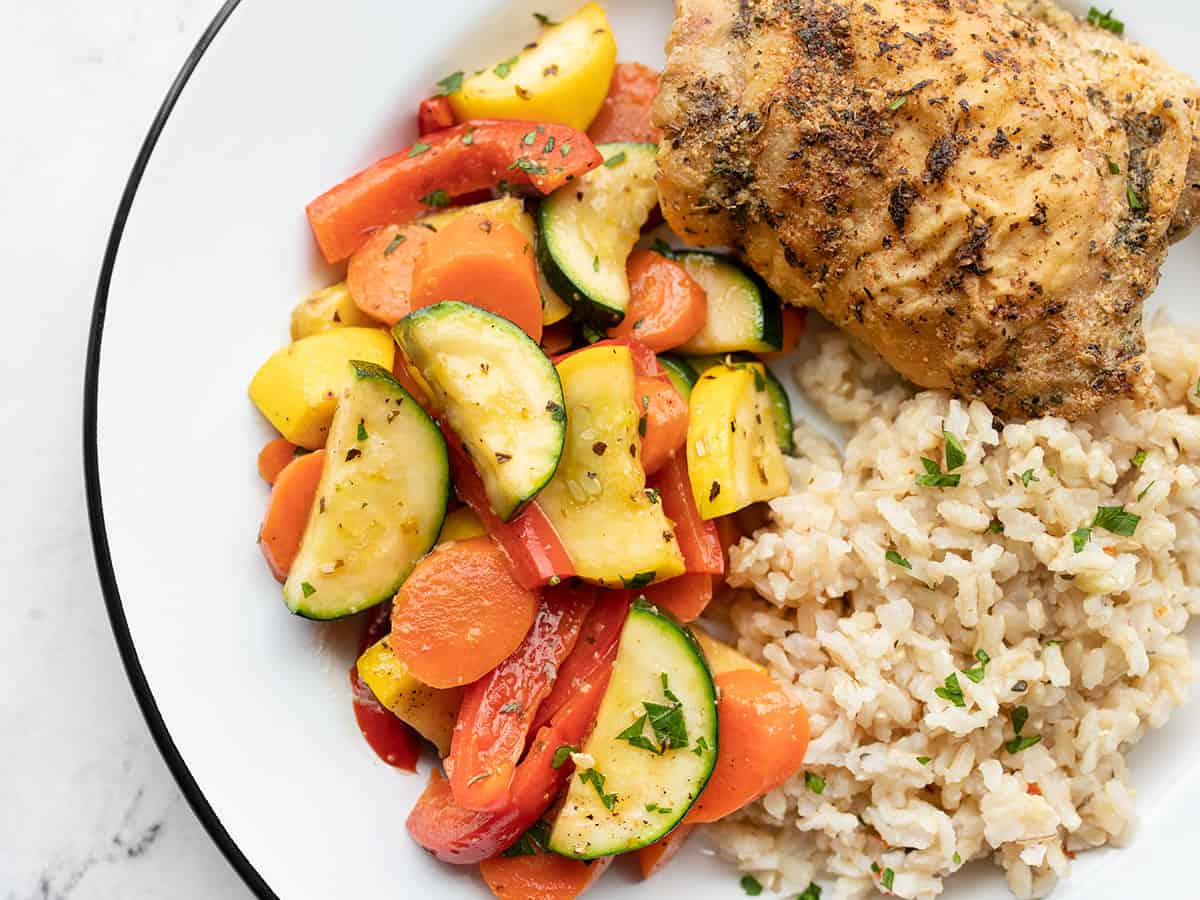 Sautéed Vegetables on a plate with chicken and rice