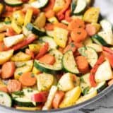 Side view of sautéed vegetables in the skillet