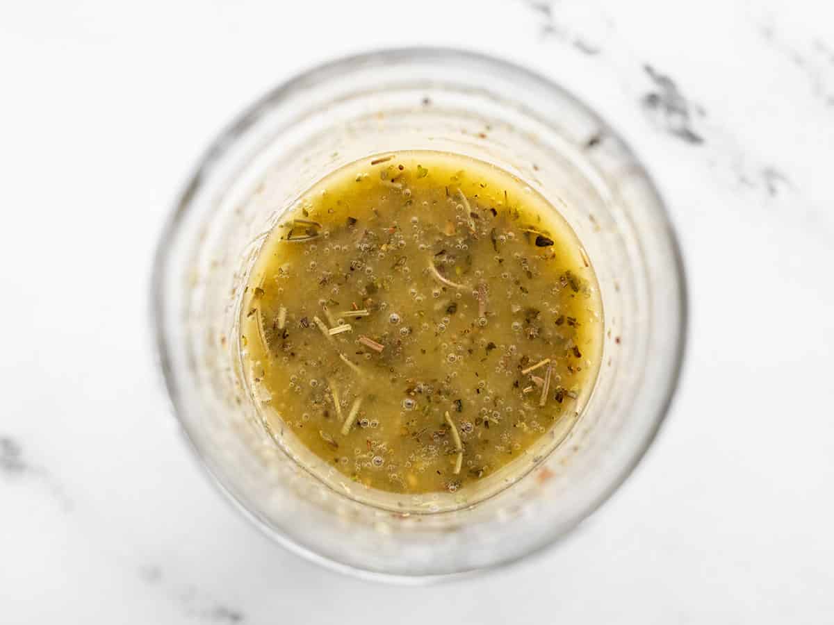 Overhead view of homemade vinaigrette in a jar.