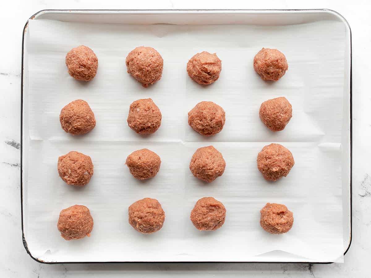 Shaped meatballs on a parchment lined baking sheet