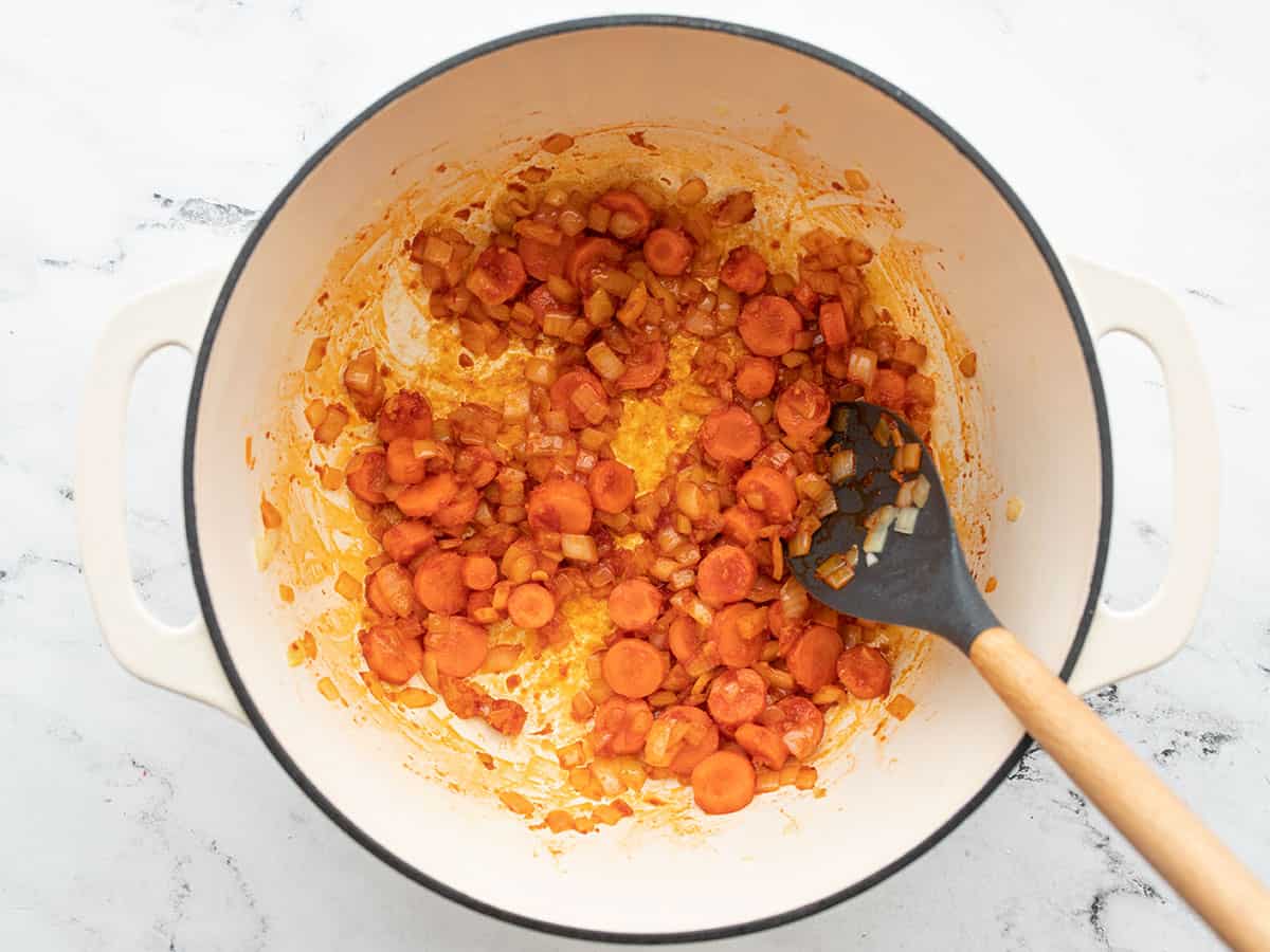 Tomato paste in the pot with vegetables