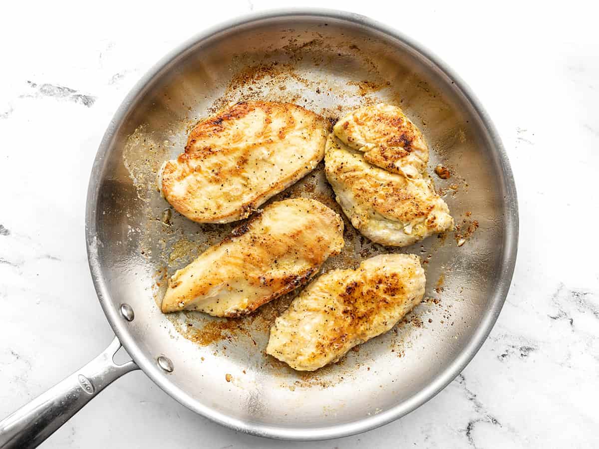 Browned chicken breasts in the skillet