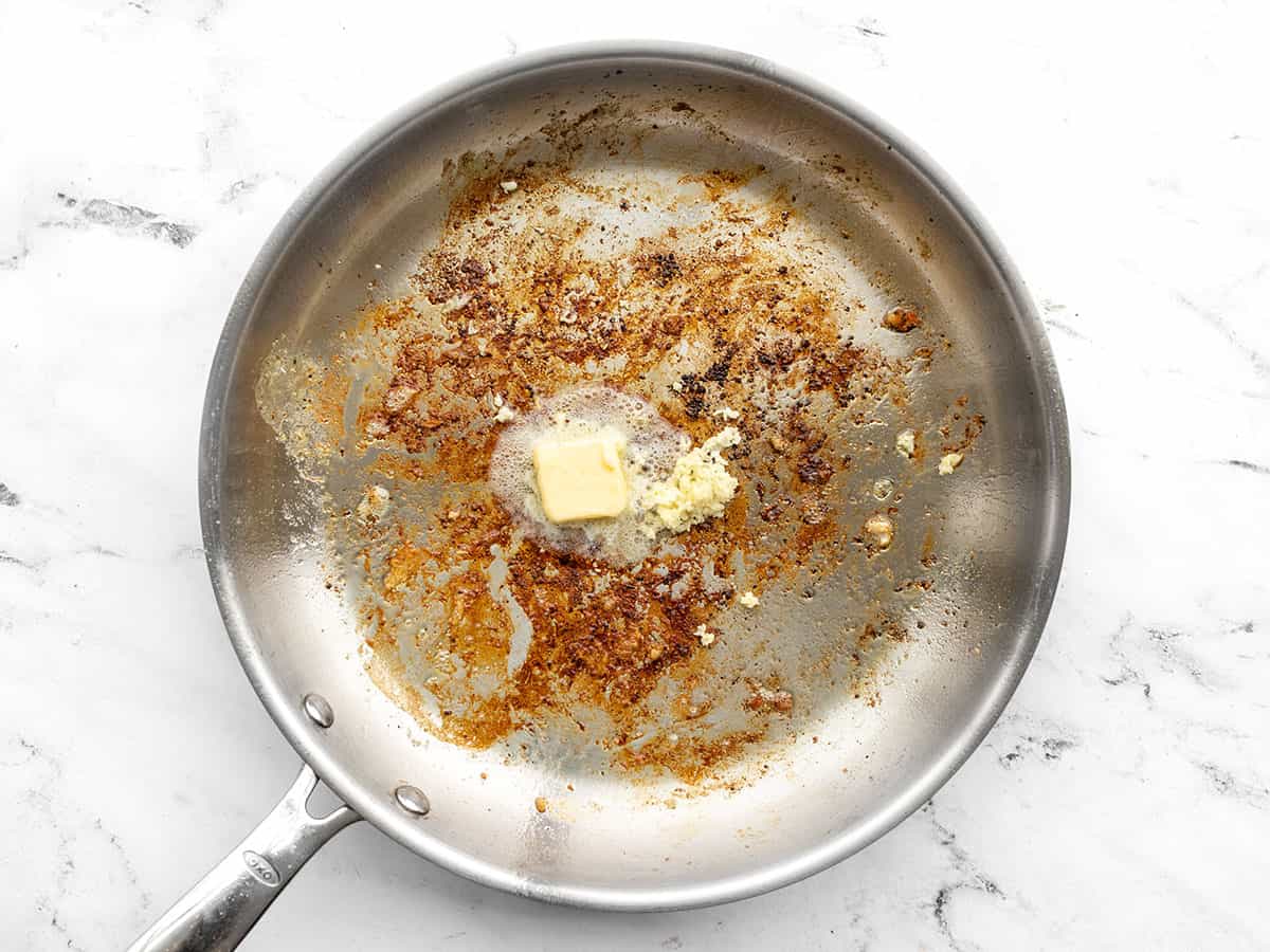 Butter and garlic added to the skillet