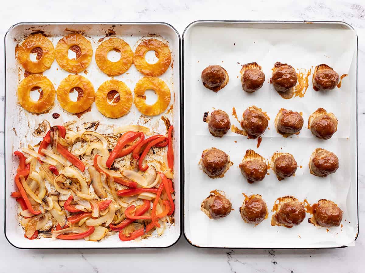 Finished sheet pans with meatballs, peppers, onions, and pineapple